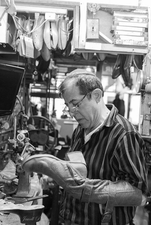Uriel repairing a boot at his workshop